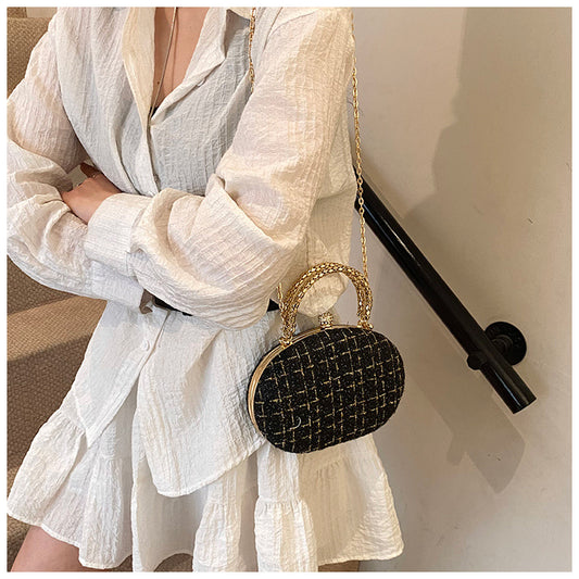 The Noire Luxe Oval Clutch – Black & Gold Plaid