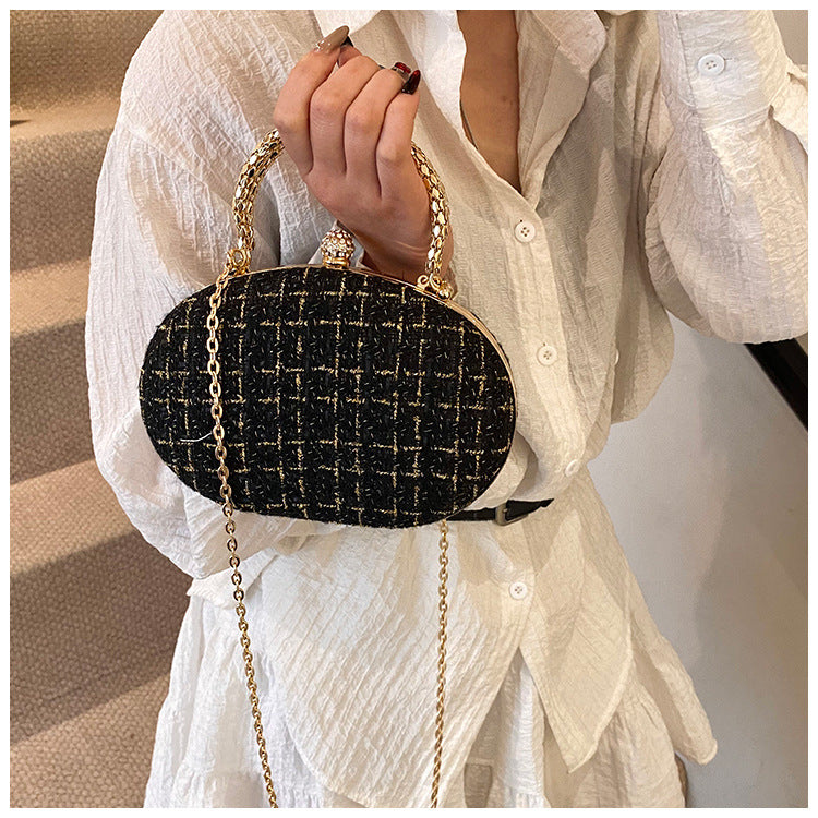 The Noire Luxe Oval Clutch – Black & Gold Plaid